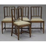 A set of four 20th century mahogany spindle back dining chairs, the upholstered drop-in seats raised