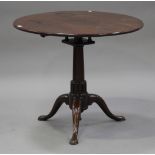 A George III mahogany circular tip-top supper table, fitted with a birdcage mount above a turned