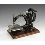 A 19th century Willcox & Gibbs cast iron sewing machine, with original pine case. Buyer’s Premium