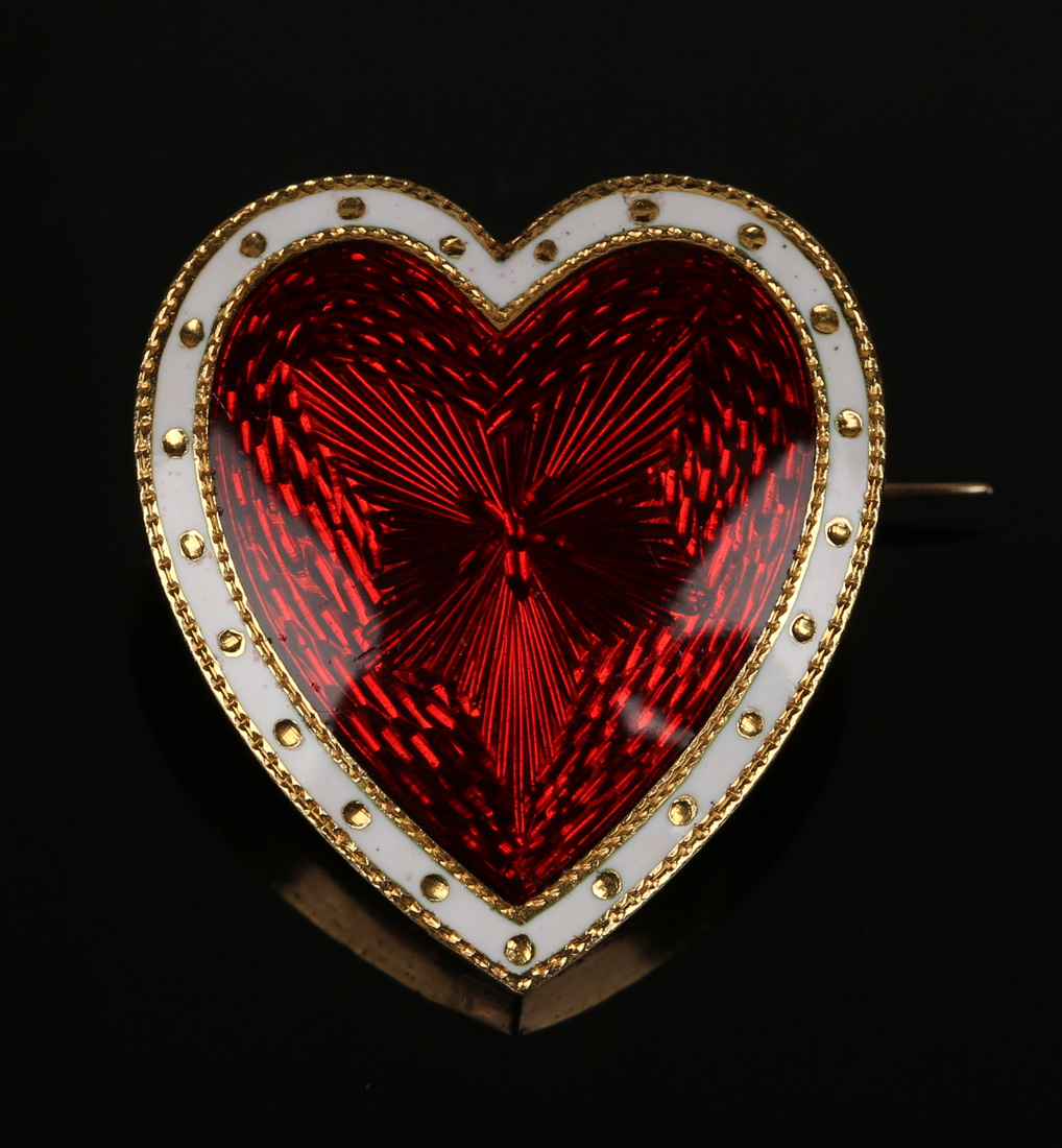 A gold and enamelled heart shaped brooch, the front with red guilloche enamelled decoration within a