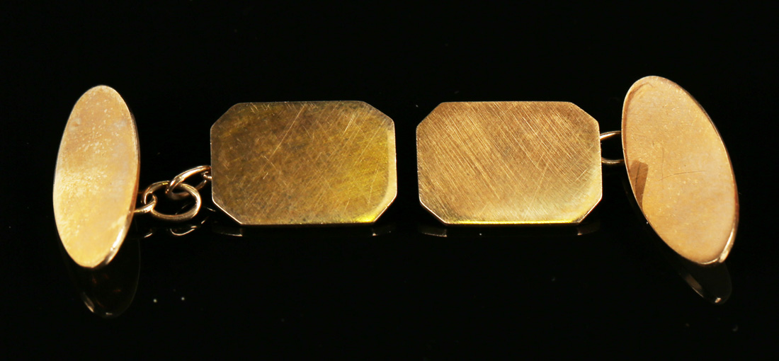 A pair of 9ct gold cufflinks, each cut cornered rectangular front with an oval back, London 1942.