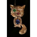 A gold, sapphire, seed pearl, garnet and gem set brooch, designed as a caricature of a cat, detailed