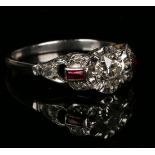 A platinum, diamond and synthetic ruby ring, claw set with the principal cushion shaped diamond