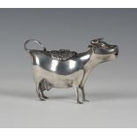 A late 19th/early 20th century Continental silver cow creamer, modelled standing square with tail