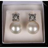 A pair of 18ct white gold, diamond and South Sea pearl earrings, each pearl with square surmount set