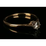 A gold, platinum and diamond single stone ring, claw set with a circular cut diamond, ring size