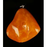 An amber butterscotch coloured pendant of irregular form, weight 8.5g, length 4cm.Buyer’s Premium