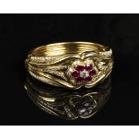An Asprey 18ct gold, diamond and ruby oval hinged bangle, claw set with the principal oval cut