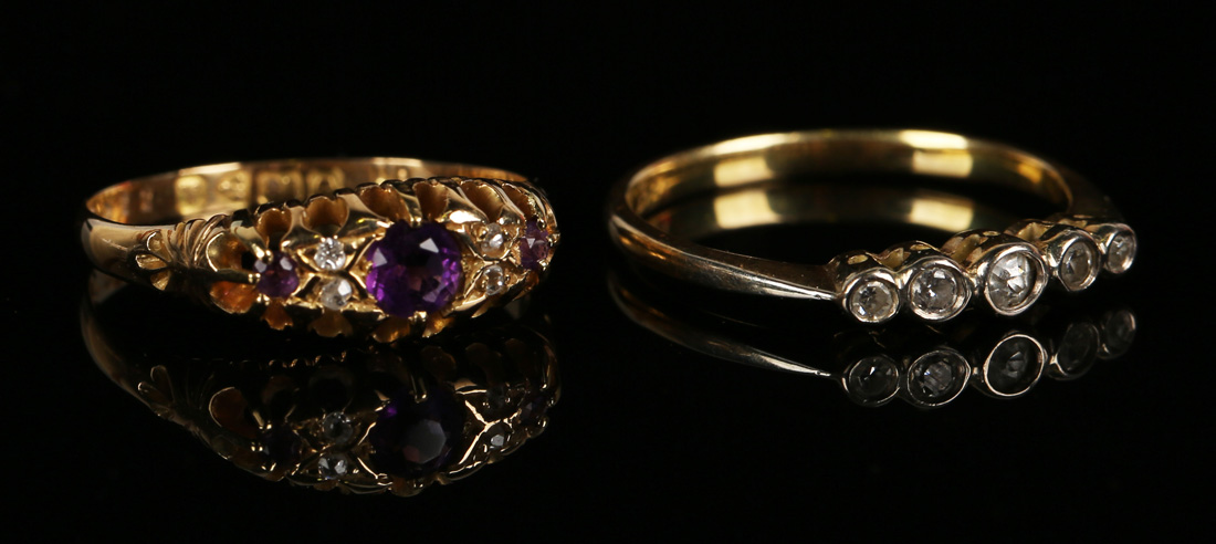 An 18ct gold, amethyst and diamond ring, mounted with three cushion shaped amethysts alternating