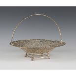 A Chinese silver circular cake basket, pierced and engraved with birds amidst bamboo, with a