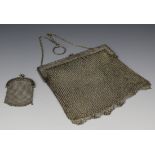 An early 20th century Chinese silver chain mesh evening bag, the snap clasp decorated in relief with