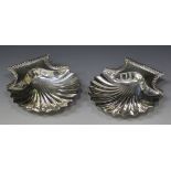 A pair of early Victorian silver butter shells, each with a gadrooned rim handle, on three shell
