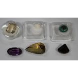 Four unmounted faceted gemstones, including amethyst and smoky quartz, an unmounted opal and an