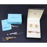 A Tiffany & Co silver tie slide, designed as a nautical knot, with a Tiffany & Co pouch and box, a