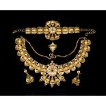 An Indian gold parure, comprising a collar necklace, a bracelet, a pair of pendant earrings with