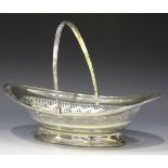 A George III silver bread basket of oval form with reeded swing handle above an engraved unicorn