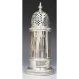 A George VI silver sugar caster with pierced domed cover and urn finial above a tapering cylindrical