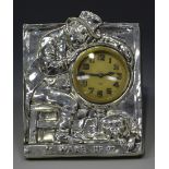 An Edwardian silver mounted bedside clock frame of rectangular form, decorated in relief with a