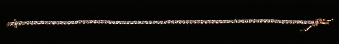 An 18ct rose gold and diamond bracelet, claw set with a row of circular cut diamonds, on a snap