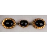 A pair of gold and cabochon amethyst dress cufflinks, each mounted with an oval cabochon amethyst