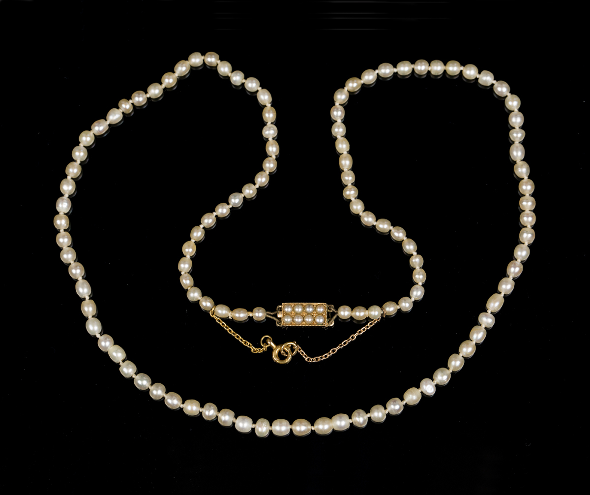 A single row necklace of one hundred and eleven graduated natural saltwater pearls, on a rectangular