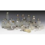 A collection of silver mounted glass bottles, jars and scent bottles, including a pair of square