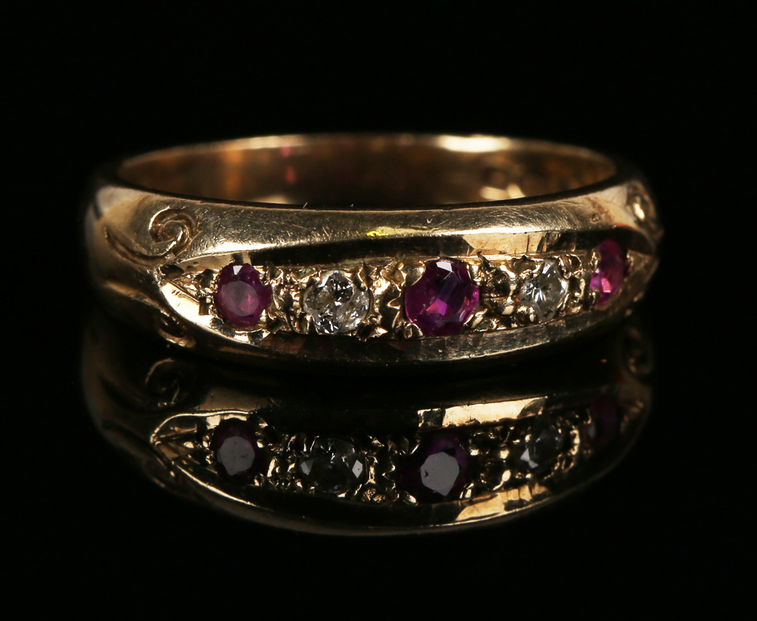 A 9ct gold, ruby and diamond five stone ring, mounted with three circular cut rubies alternating