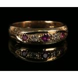 A 9ct gold, ruby and diamond five stone ring, mounted with three circular cut rubies alternating