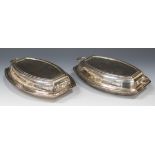 A pair of George V silver two-handled entrées dishes and covers of curved rectangular form,