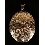 A 9ct gold oval pendant locket, the front with scroll engraved decoration, Birmingham 1975, length