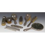 A group of George V silver mounted dressing table items, comprising two hairbrushes, a clothes
