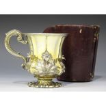 A William IV silver gilt christening mug of tapering lobed form with four relief decorated stems