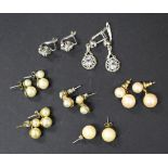 A pair of white gold and colourless gem set earrings, another pair of colourless gem set earrings