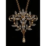 A two colour gold, diamond and cultured pearl pendant of scrolling stem form with foliate detail,