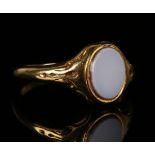 A gold and sardonyx oval signet ring with decorated shoulders, ring size approx N1/2.Buyer’s Premium