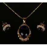 A gold, cabochon amethyst and colourless gem set oval pendant, length 3.2cm, with a gold