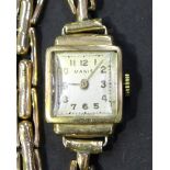 A Manis 9ct gold shaped square cased lady's wristwatch, the signed square dial with Arabic numerals,