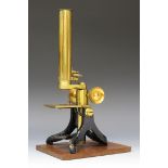 A late 19th century lacquered and black enamelled brass monocular microscope, unsigned, with rack
