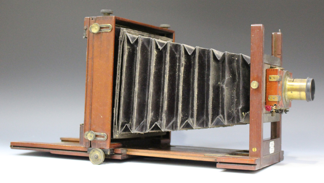 A late 19th century mahogany and lacquered brass folding plate field camera with black leather