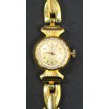 An Omega gold circular cased lady's wristwatch, the signed circular dial with gilt baton numerals,