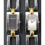 A Nina Ricci gilt metal and steel lady's bracelet wristwatch with a grey dial, and another Nina