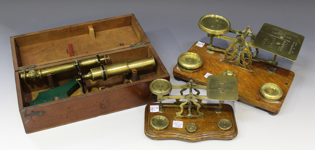 A mid-19th century brass monocular microscope with engraved presentation inscription, on a green