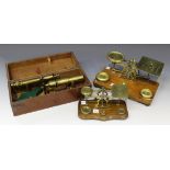 A mid-19th century brass monocular microscope with engraved presentation inscription, on a green