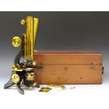 A late 19th century gilt lacquered and oxidized brass binocular microscope, signed 'J. Swift &