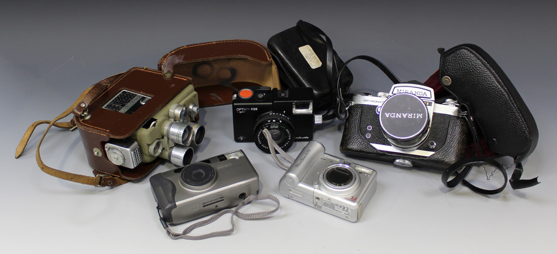 A collection of cameras and equipment, including a Miranda Sensomat RE camera, an Auto Miranda 1:3.8