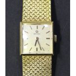 An Omega 18ct gold lady's bracelet wristwatch, the signed square silvered dial with gilt baton