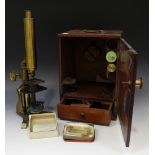 A late 19th century lacquered brass monocular microscope with rack and pinion focusing and plano-