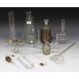 A collection of various glass chemistry and laboratory glassware, including distillation