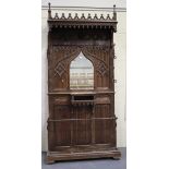 A late 19th/early 20th century Gothic Revival walnut and beech hallstand, the canopied pediment