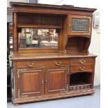 A late Victorian Arts and Crafts style walnut sideboard by Maple & Co, the mirror and shelf back